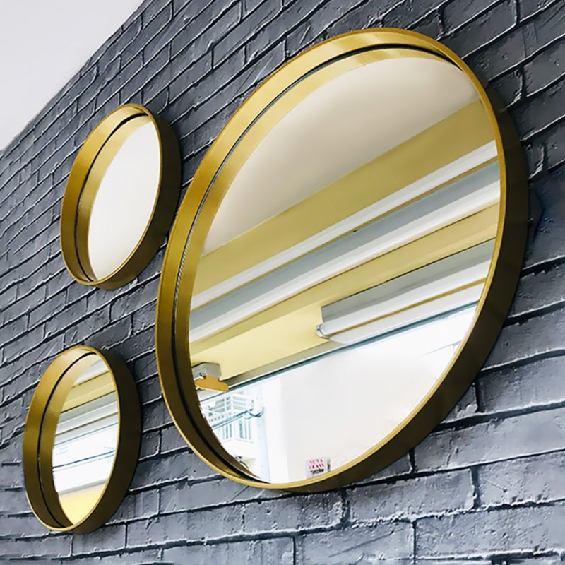 Composition of round bathroom wall mirrors made of metal in gold color set of 3 pieces